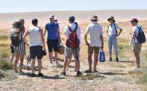 John rensten teaching a group about seashore foraging