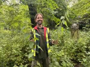 Man holding large foraged nettles