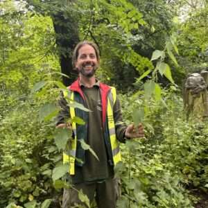 Man holding large foraged nettles