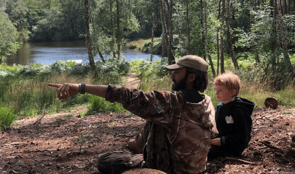 Man and Child identifying foraged plants in woods